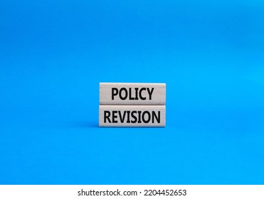 Policy Revision Symbol. Concept Word Policy Revision On Wooden Blocks. Beautiful Blue Background. Business And Policy Revision Concept. Copy Space