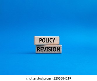 Policy Revision Symbol. Concept Word Policy Revision On Wooden Blocks. Beautiful Blue Background. Business And Policy Revision Concept. Copy Space