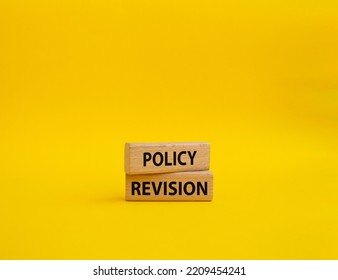 Policy Revision Symbol. Concept Word Policy Revision On Wooden Blocks. Beautiful Yellow Background. Business And Policy Revision Concept. Copy Space