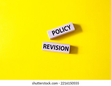 Policy Revision Symbol. Concept Word Policy Revision On Wooden Blocks. Beautiful Yellow Background. Business And Policy Revision Concept. Copy Space