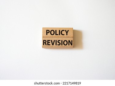 Policy Revision Symbol. Concept Word Policy Revision On Wooden Blocks. Beautiful White Background. Business And Policy Revision Concept. Copy Space