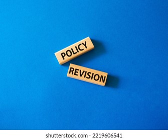 Policy Revision Symbol. Concept Word Policy Revision On Wooden Blocks. Beautiful Blue Background. Business And Policy Revision Concept. Copy Space