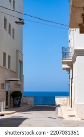 Polignano A Mare Street View With Blue Sky In Front Of The Sea. Apulia, Italy. 