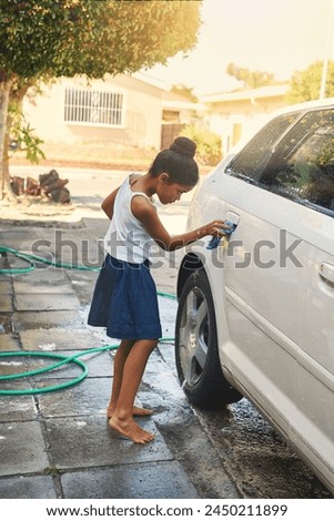 Polish, car and girl cleaning in driveway with water, soap and cloth at home. Happy kid, washing and vehicle at home for helping, polishing and learning lessons for responsibility in backyard