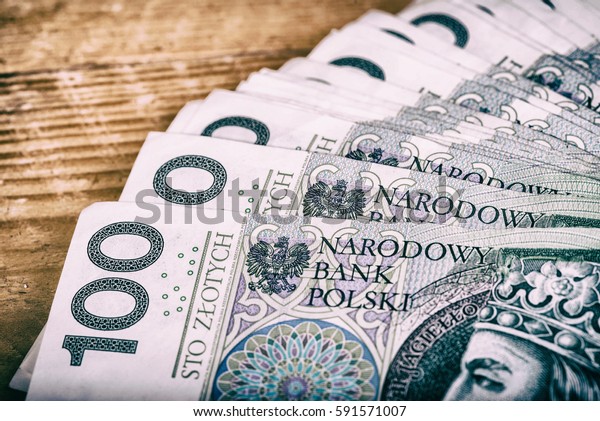Polish currency PLN, money. File ,roll of\
banknotes of 100 PLN (Polish\
zloty)