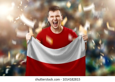 Polish Fan, A Fan Of A Man Holding The National Flag Of Poland In His Hands. Soccer Fan In The Stadium.