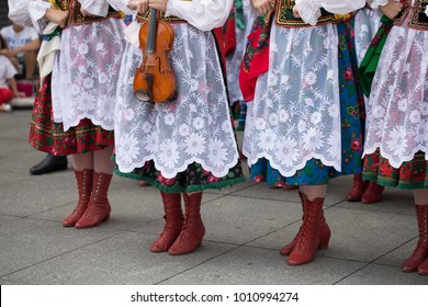 Polish Folk Dance Group With Traditional Costume And A Violin