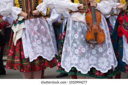 Polish Folk Dance Group With Traditional Costume And A Violin