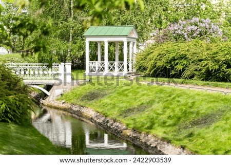 Polish garden at the Derzhavin estate. Gorgeous spring bloom. Pond, bridge