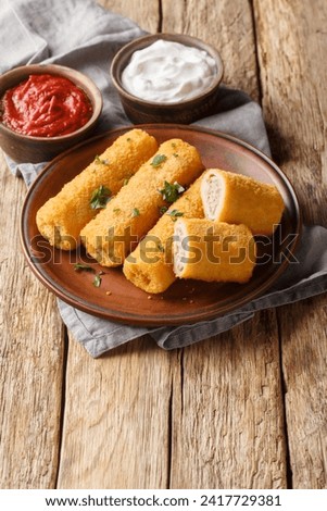 Polish Krokiety Croquettes with ground meat served with sauces closeup on the plate on the wooden table. Vertical
 Zdjęcia stock © 