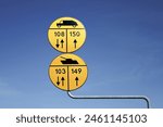 Polish military road signs with a blue sky background.