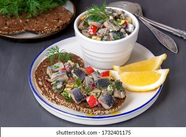 Polish Pickled Herring In Oil. Open Sandwich With Sliced Fish And Apple-onion Relish On Rye Toast Bread With Seeds.