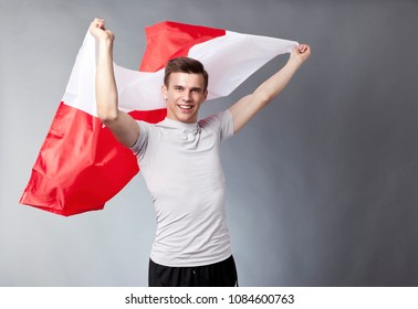 Polish Supporter. Football Fan With Polish Flag In His Hands. Soccer Championship Or National Day Celebration Concept