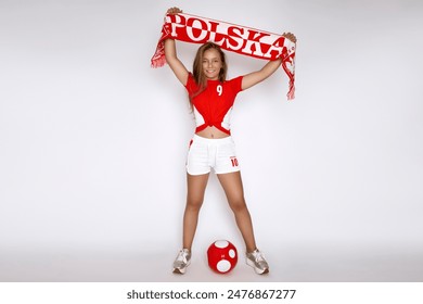 Polish young happy girl in sports outfit hold the Polish red and white flag and support the Polish team in the soccer championship. Polish representation - Powered by Shutterstock