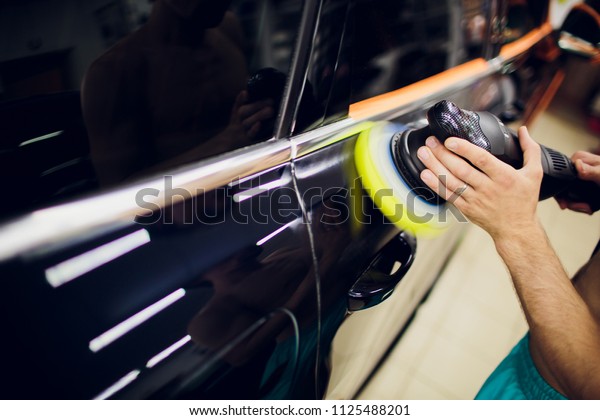 Polished black car polishing machine\
polished finishing. Car detailing. Selective\
focus.