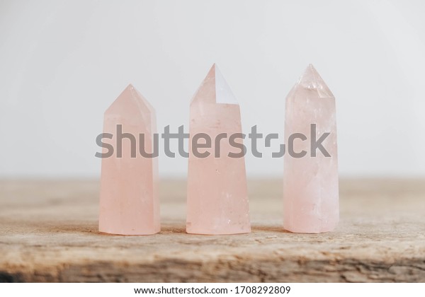Polished crystals rose quartz gemstone on a\
wooden table. Copy, empty space for\
text