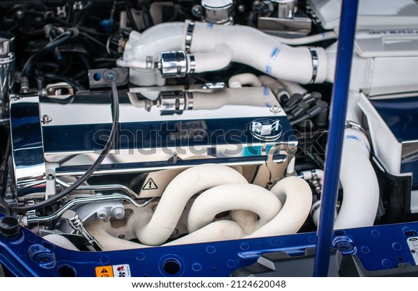 Polished up parts of a performance car with\
visible exhaust\
manifold