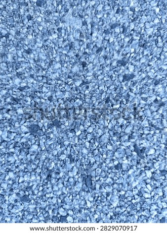 Polished white aggregate paving surface with cool bluish undertones and dark chips.

