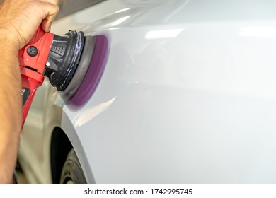 Polishing The Car Body With A Manual Automatic Grinder With Wax And Polishing Paste