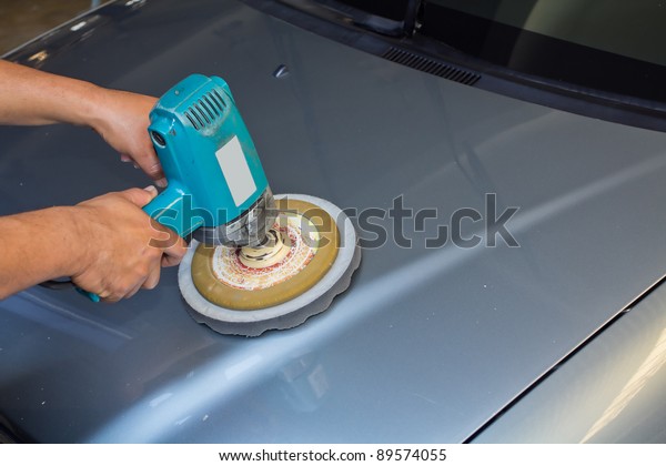 Polishing the car. with\
power buffer machine . CAR CARE images closeup Useful as background\
for design-works.