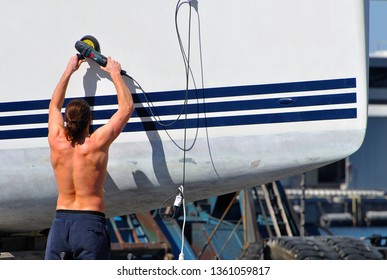 Polishing And Cleaning The Hull Of The Yacht