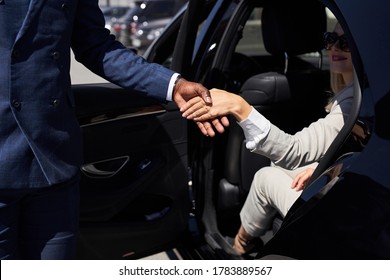 Polite Taxi Driver Help Business Woman Get Out Of Car, Kind Man Give Hand To Woman In Formal Wear. Smile, Show Politeness, Hospitality