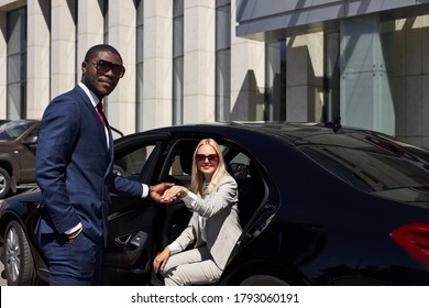 Polite Taxi Driver Help Business Woman Get Out Of Car, Kind Man Give Hand To Woman In Formal Wear. Smile, Show Politeness, Hospitality