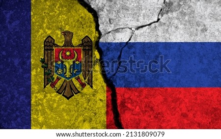 Political relationship between Moldova and russia. National flags on cracked concrete background