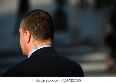 Politician Bodyguard Communicating Through An Earpiece.