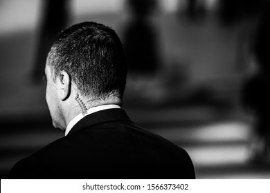 Politician Bodyguard Communicating Through An Earpiece.