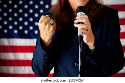 Politician: Woman Speaking Strongly At Microphone