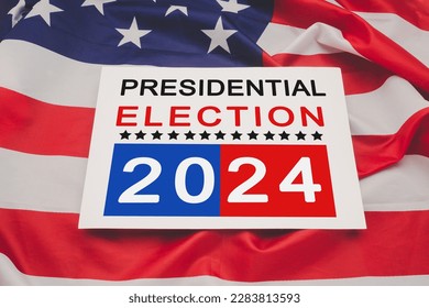 Politics and voting concept. Presidential election 2024 text on white paper over the American flag background