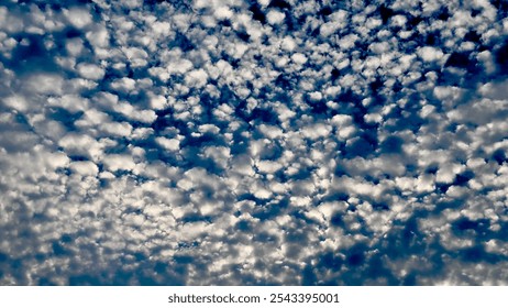 polka dot cloud scape in a deep blue and turquoise sky