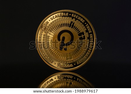 Polkadot DOT Cryptocurrency physical coin placed on reflective surface in the dark background