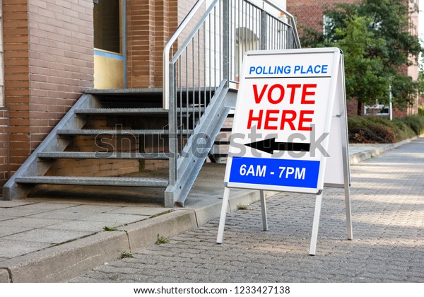 Polling\
Place Vote Here Sign On White Board Near\
House