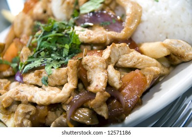 Pollo Chicken Strips Saltado Authentic Peruvian Food Dish With Rice And Herbs Photographed In Lima, Peru, South America