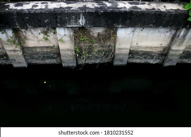 Polluted Black Dirty Wastewater Canal In City Community Of Bangkok.