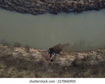 Polluted river. Hazardous chemicals are released into the river. Industrial waste water, aerial done view. Sewage drains into the river. Environmental pollution. Ecological catastrophe. Contamination. - Shutterstock ID 2170860905