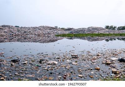 Polluted Water And Mountain Large Garbage Pile And Pollution, Pile Of Stink And Toxic Residue