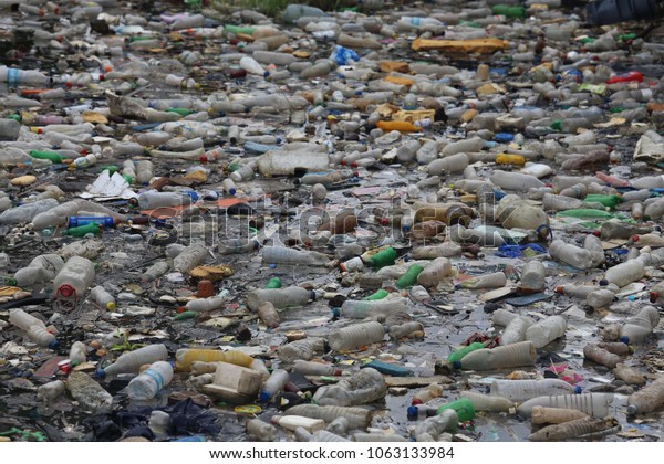 Pollution by plastic bottles in the water. Pattern
of dirty floating objects in the sea. Symbol of a major
environmental problem caused by the waste of the urban
overconsumption. Abstract
image.