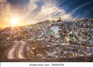 Pollution Concept. Garbage Pile In Trash Dump Or Landfill At Sunset.