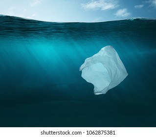 Pollution Concept. Plastic Bag Floating In The Ocean With Copy Space