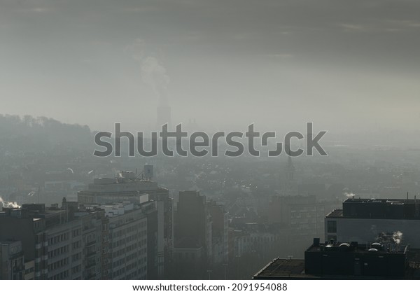 Pollution over a city. A smog hazy atmosphere\
during a winter cloudy day. Top view over the urban place for a lot\
of people. Global\
warming.