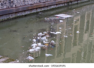 Pollution Of Plastics On The Water, Garbage Floating On River Due To Human Over Consumption Of Bottles And Junk Food