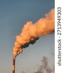 Pollution smoke stack rising against a sunset sky, highlighting industrial impact and urgent climate concerns.