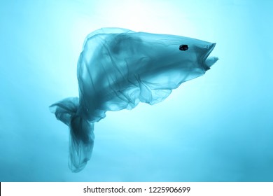 Pollution of the world's oceans with plastic garbage. Blue fish out of waste. Recycling and the ban on the use of polyethylene.