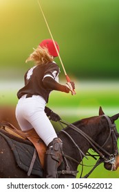 Polo woman player is riding on a horse, close-up.
