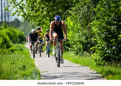 POLTAVA, UKRAINE - 19 JUNE, 2021: Cyclists ride bicycles in the park in the summer afternoon during triathlon competitions