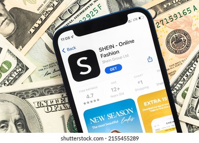 Poltava, Ukraine - April 28, 2022: Shein Fashion Shopping App Logo On Mobile Phone Screen. Business Background With Dollar Money Banknotes