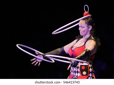POLTAVA, UKRAINE - DECEMBER 19, 2016: Gymnast turns 3 hoops (Hula hoops) during the performance of circus show Kobzov